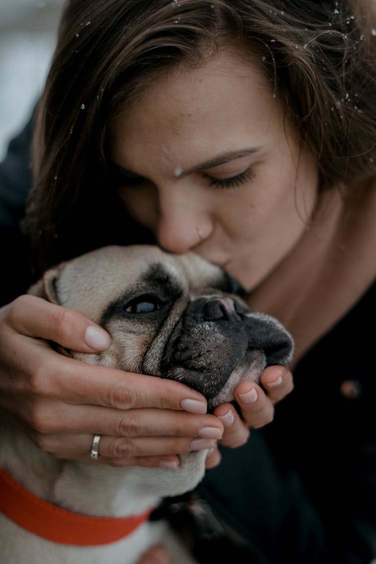 A Woman Kissing A Dog