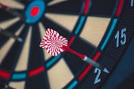 Red and White Dart on Darts Board