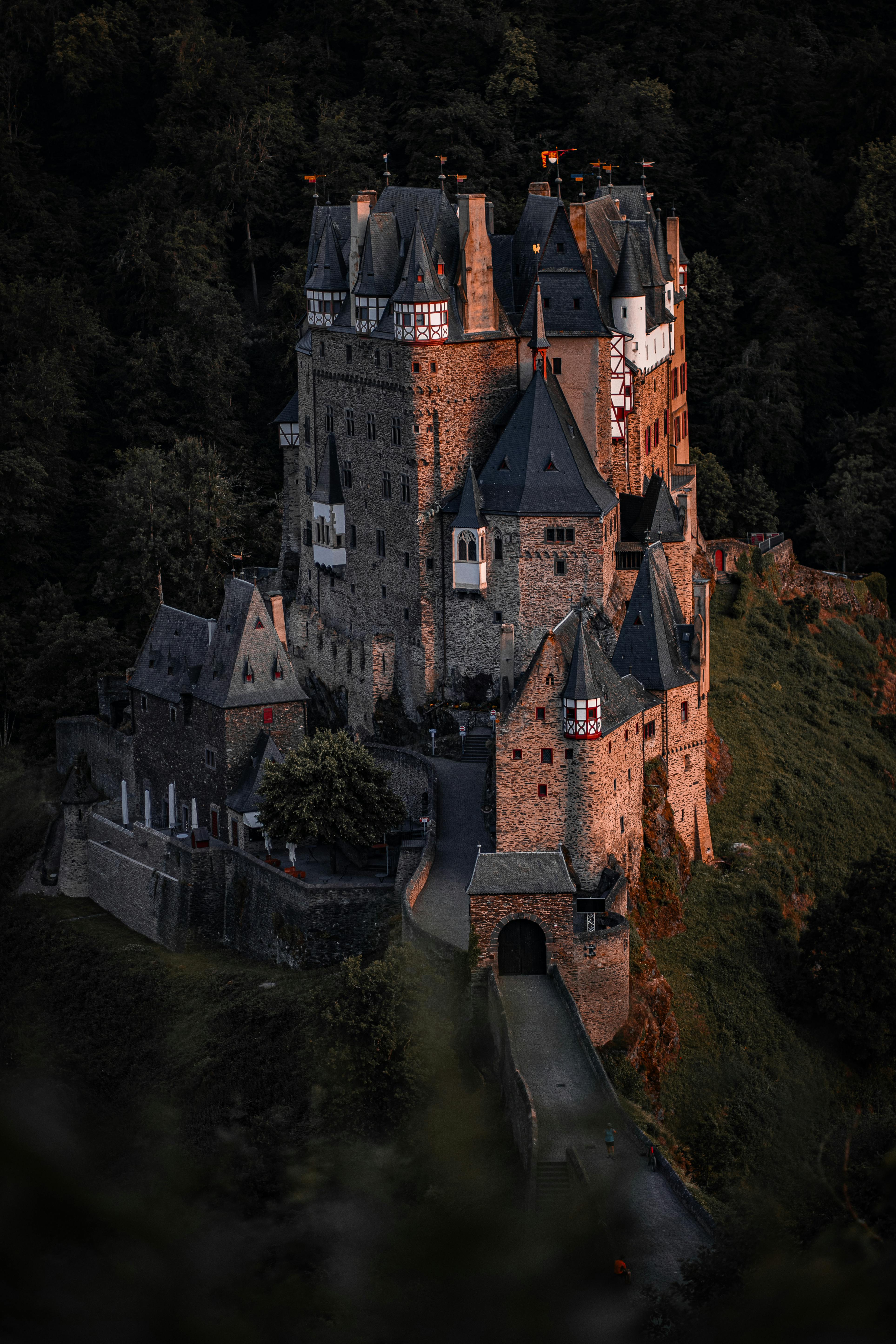 Eltz Castle stands tall amidst lush greenery in Germany, showcasing Gothic architecture.