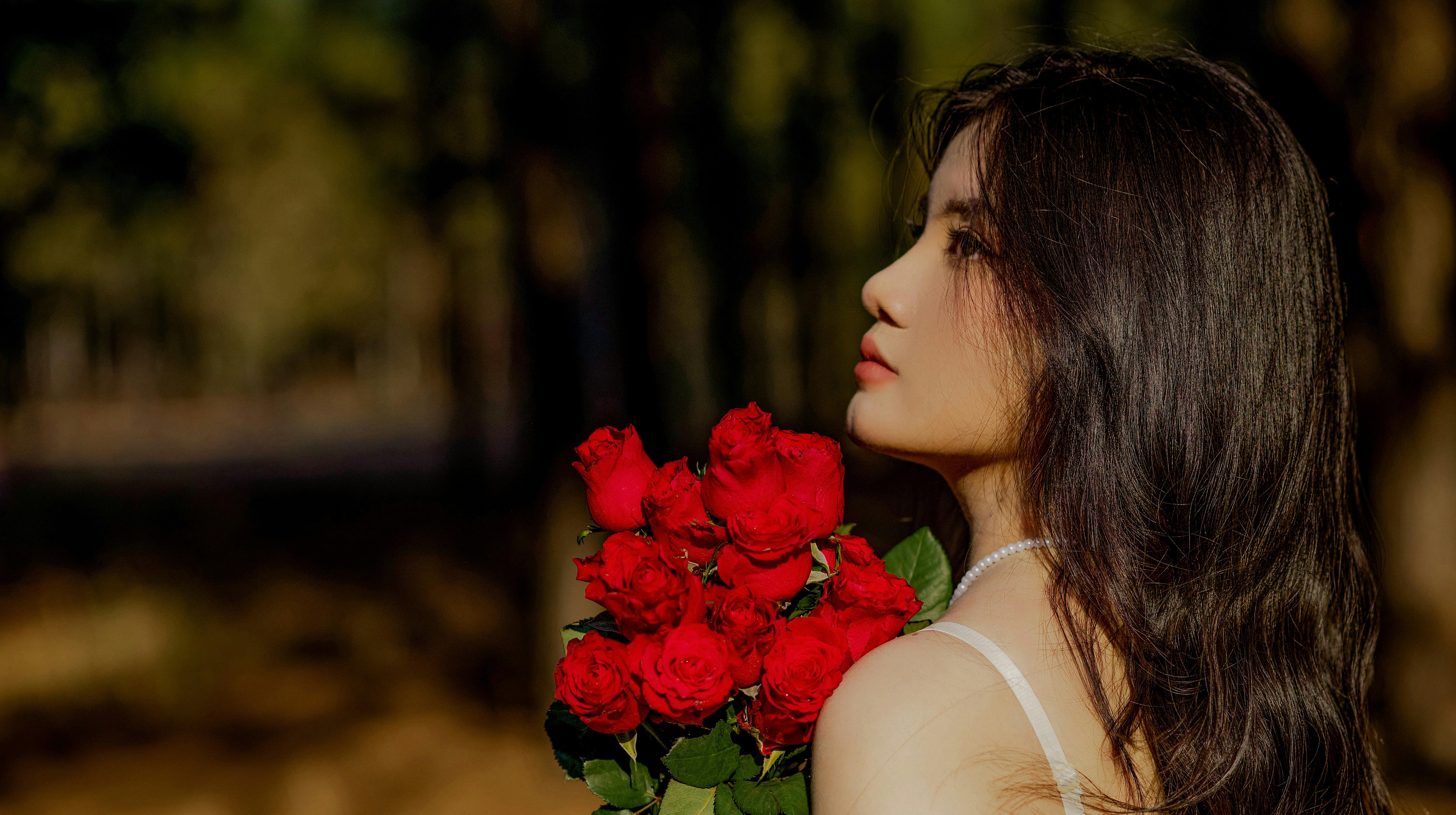 Woman with Red Roses Standing in Forest · Free Stock Photo