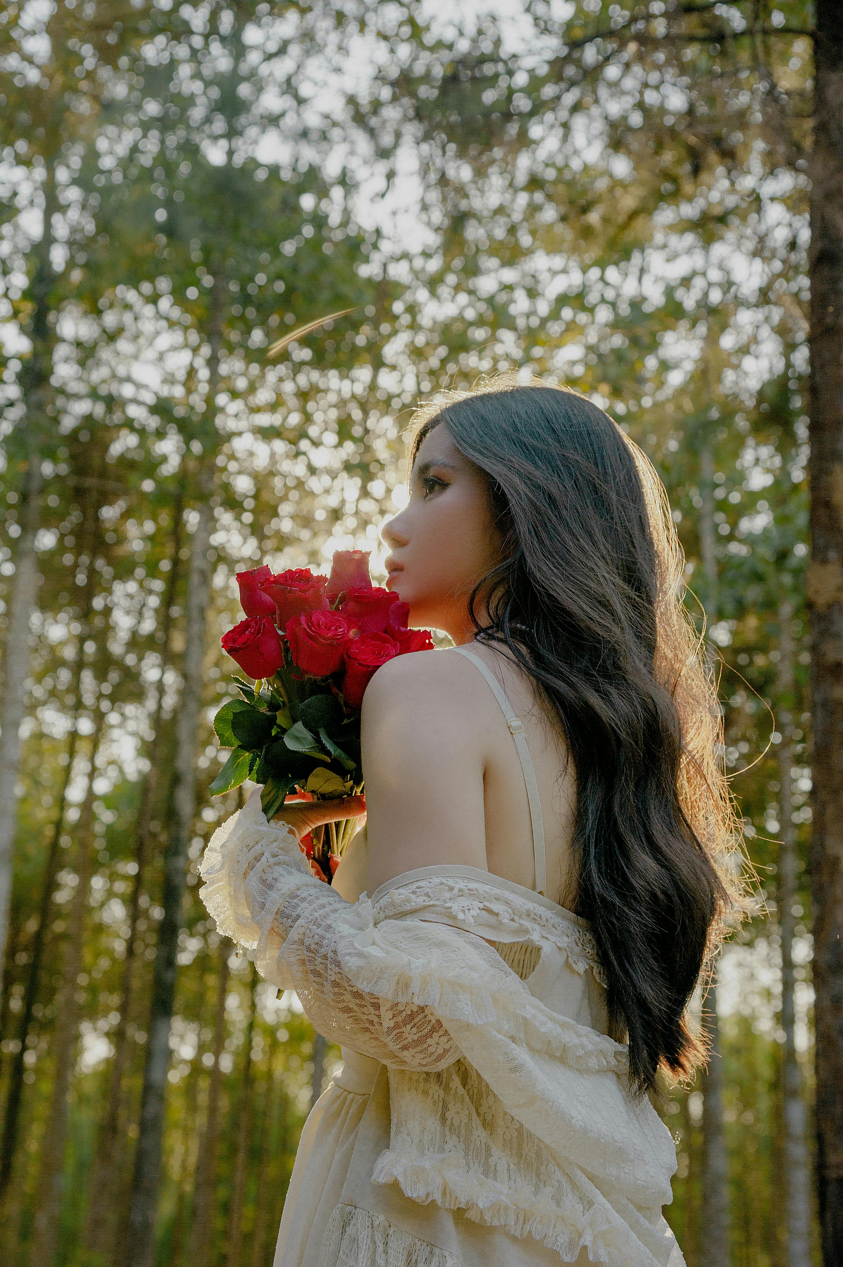 Woman with Red Roses Standing in Forest · Free Stock Photo
