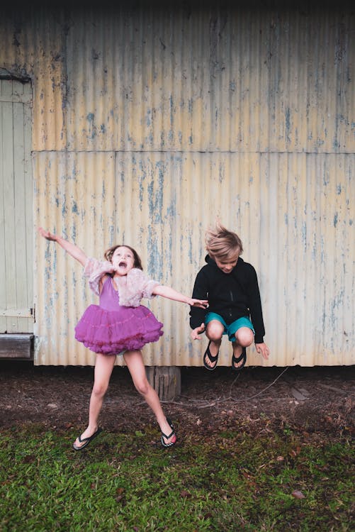 Free Photo Of Boy Jumping Beside Girl Stock Photo