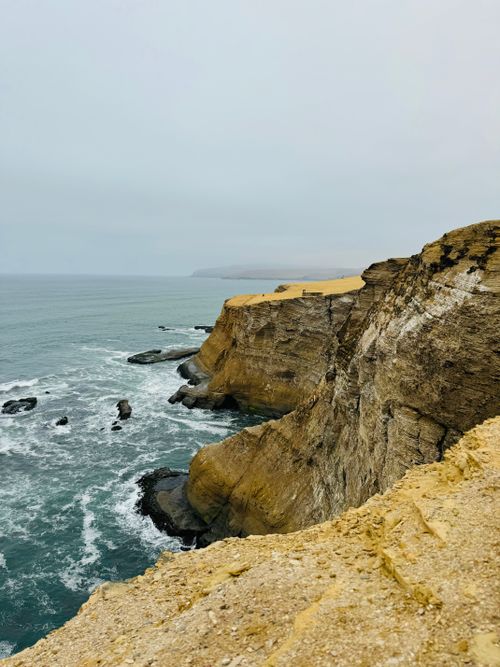 Free Experience the rugged beauty of Paracas, Peru's foggy and dramatic cliffs by the sea. Stock Photo