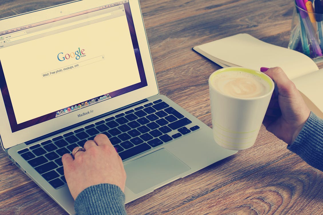 woman using Google search on her macbook air