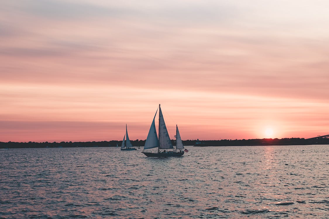 Free Two White Sailboats On Body Of Water Stock Photo