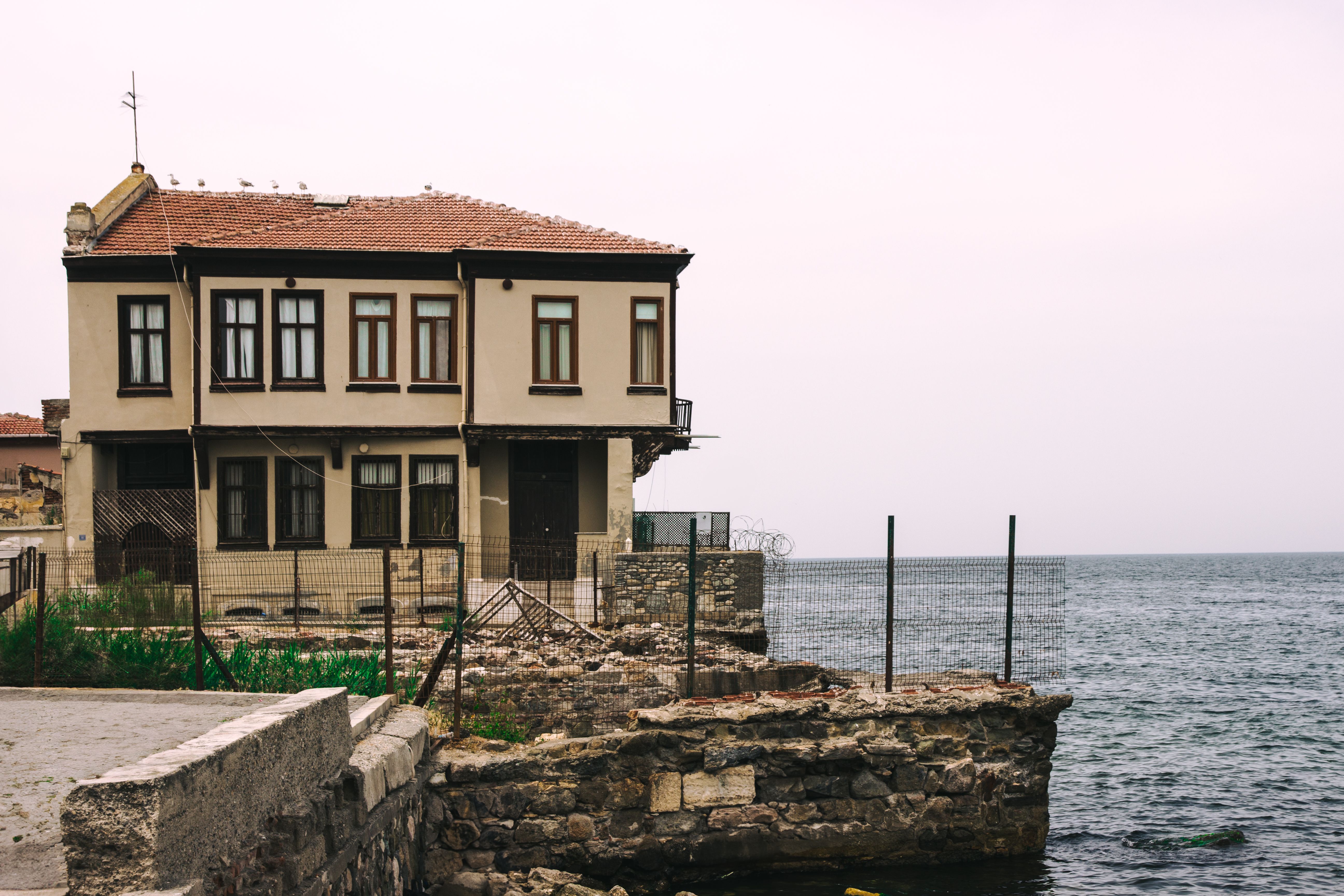 Old seaside house in Mudanya, Turkey offers a tranquil view of the sea against ancient stone textures.
