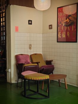 Stylish indoor corner with vintage chairs and artistic wall decor.