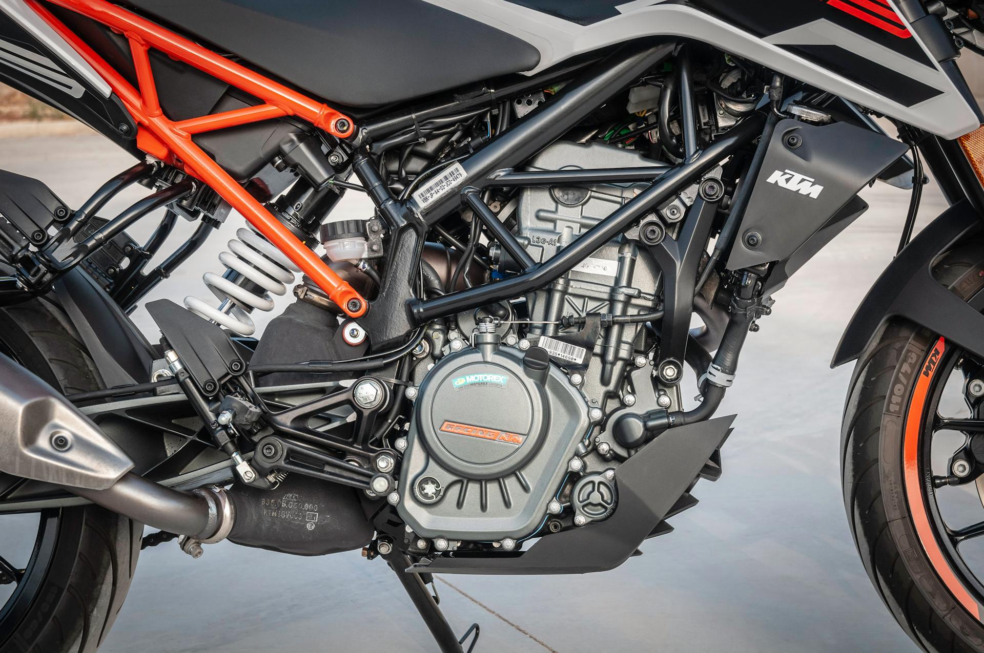 Detailed view of a KTM motorcycle engine showcasing design and machinery outdoors.