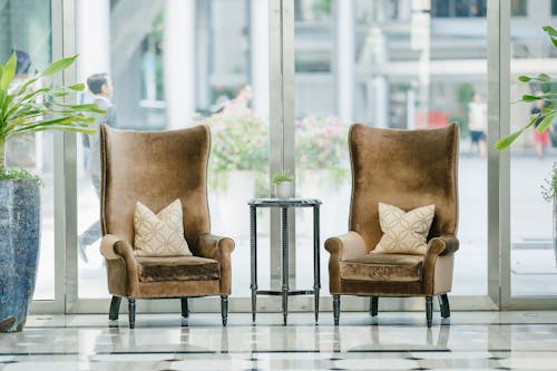 Free Photo of two brown sofa chairs near glass window Stock Photo