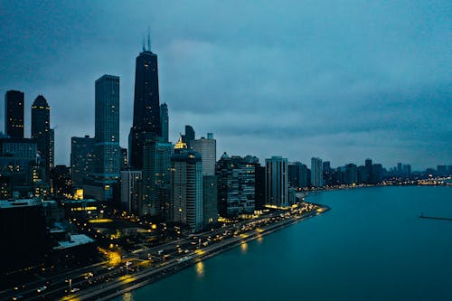 Scenic View Of City Under Cloudy Sky