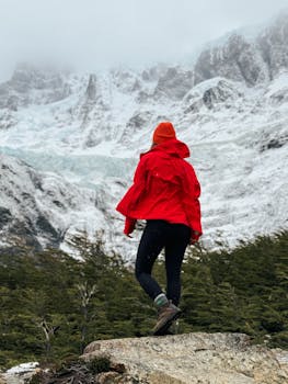 Woman hiking in the snowy mountains of Chile, showcasing a blend of adventure and nature.