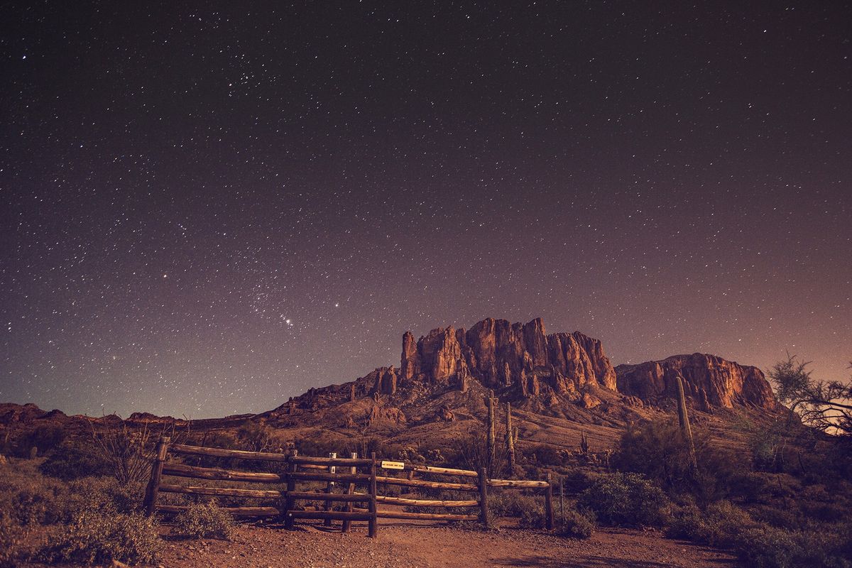 Stars over desert landscape at night