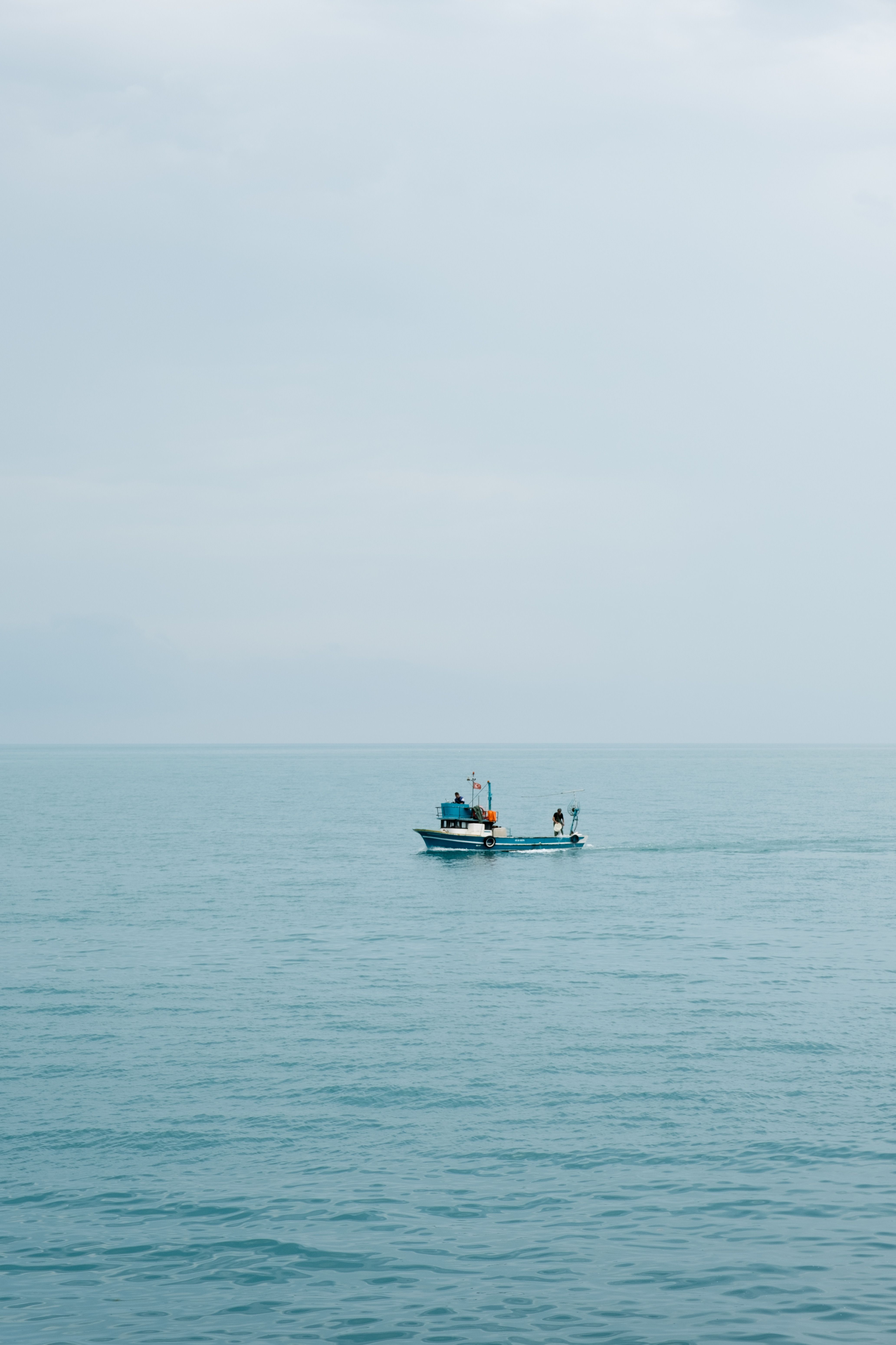 Calm fishing boat drifting on serene Black Sea near Akçaabat, Trabzon, Türkiye.
