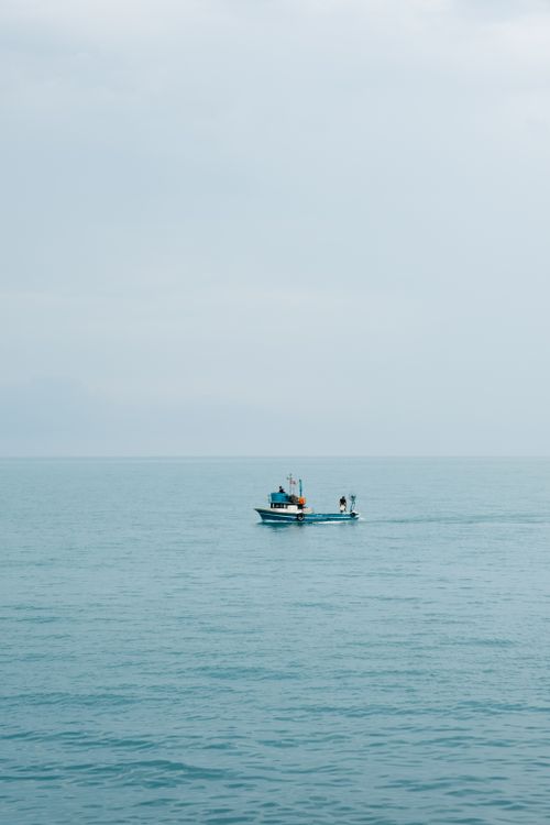 Free Calm fishing boat drifting on serene Black Sea near Akçaabat, Trabzon, Türkiye. Stock Photo