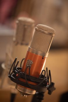 Detailed close-up of a modern studio microphone suitable for audio recording.