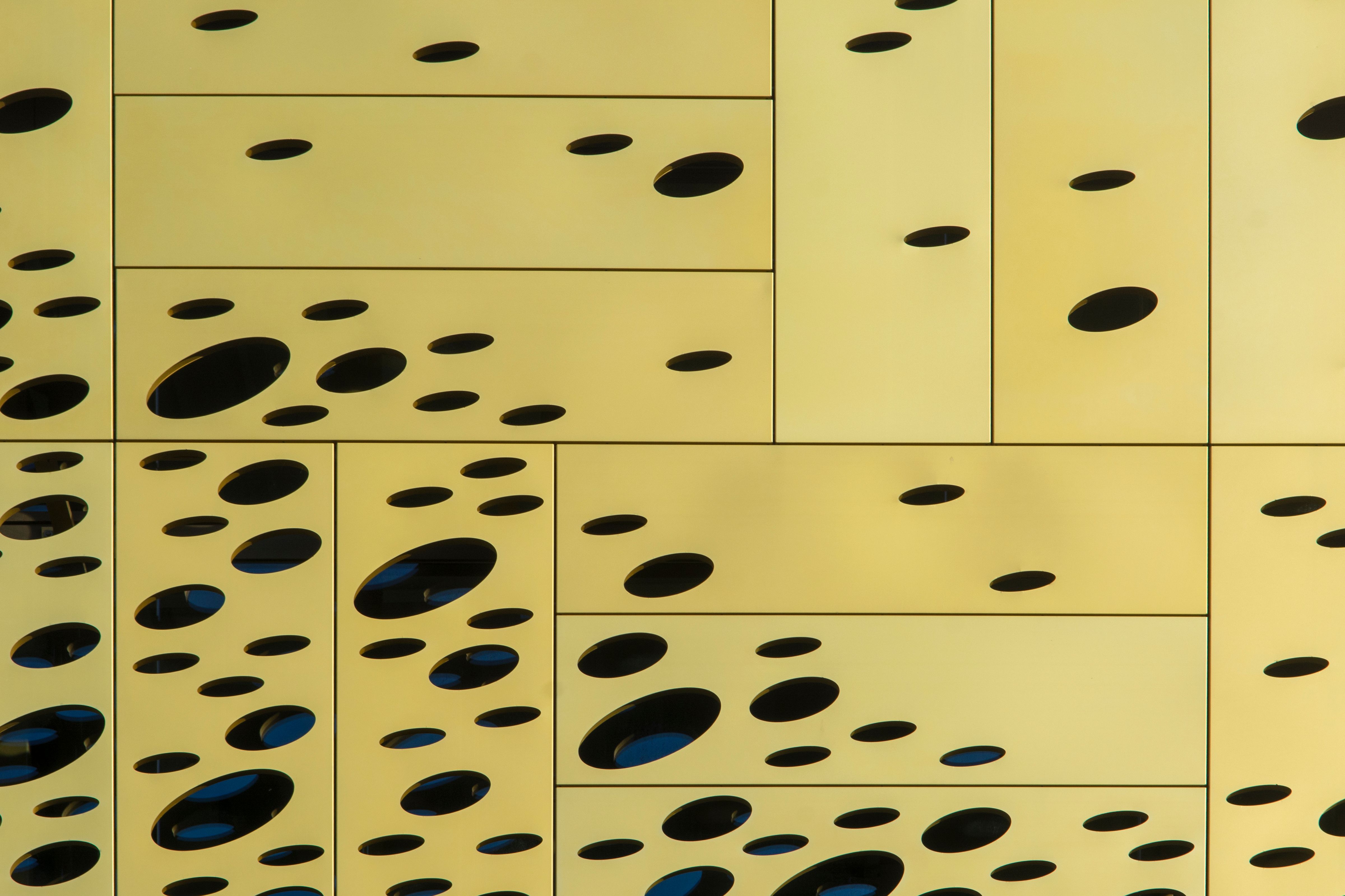 A close up of a yellow and black patterned wall · Free Stock Photo