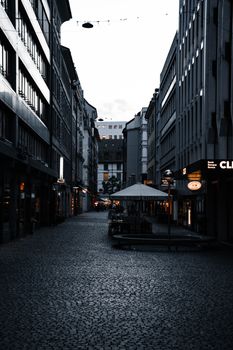 Explore the modern architecture and charming cobblestone streets of Geneva at twilight.