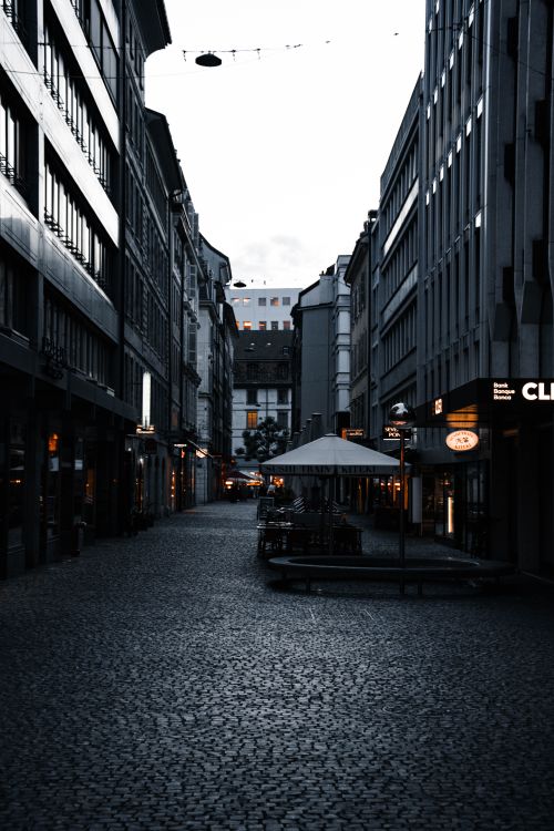 Free Explore the modern architecture and charming cobblestone streets of Geneva at twilight. Stock Photo
