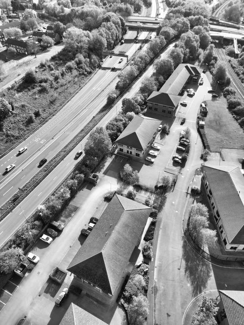 Free Aerial view of urban Derby, England, showcasing buildings, roads, and trees in black and white. Stock Photo
