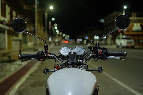 Motorcycle Parked on a City Street at Night