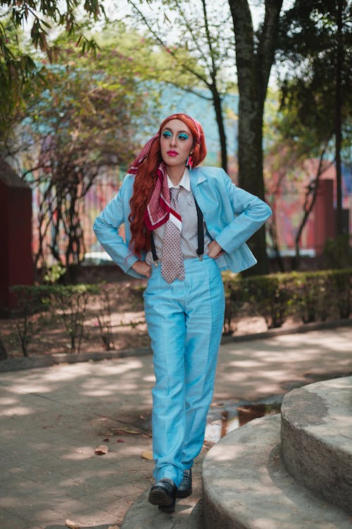 A woman in a blue suit and red hair