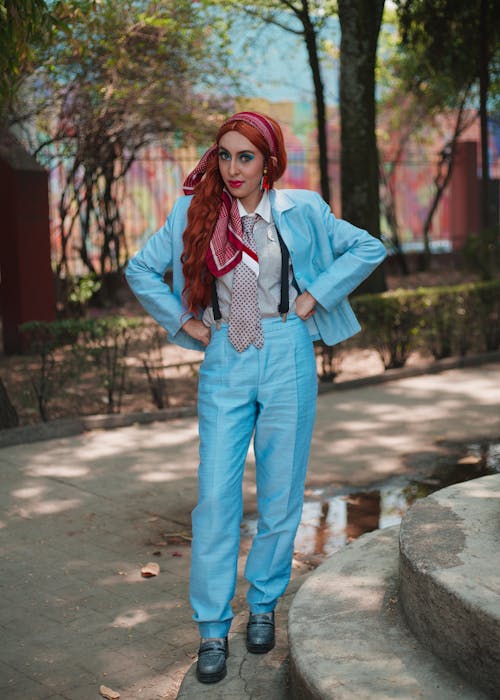 A woman in a blue suit and red hair