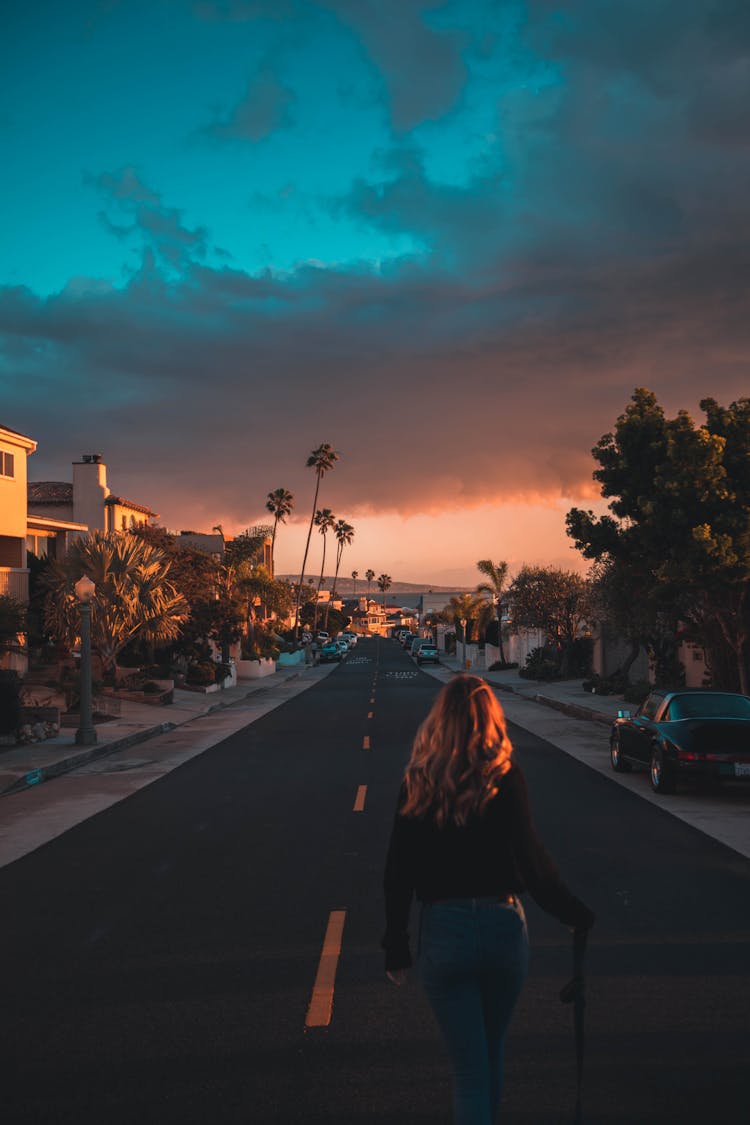 Woman Walking In The Middle Of The Road