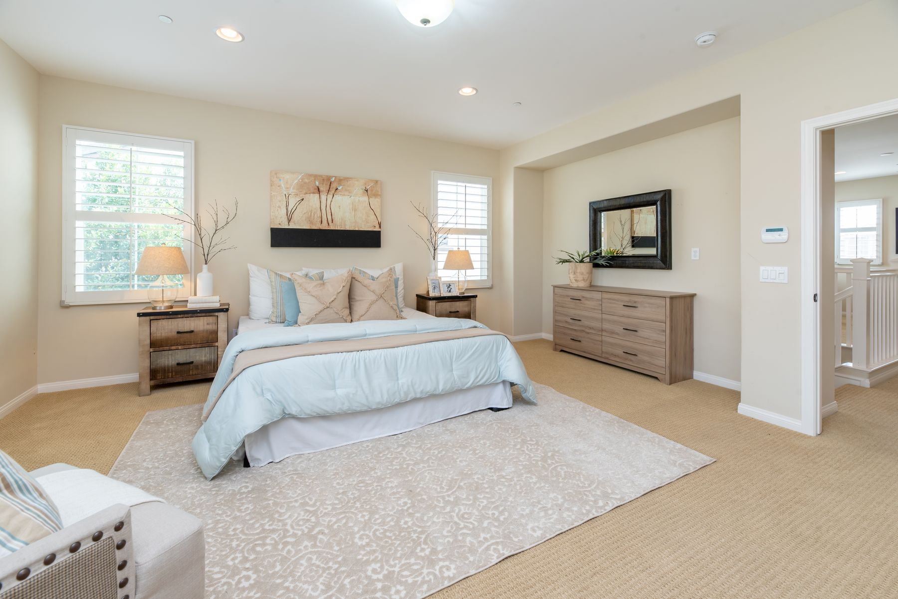Serene bed layered with pillows duvet and warm neutral textiles