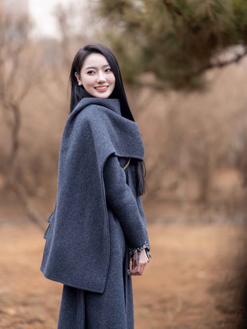 Smiling Woman in Gray Coat