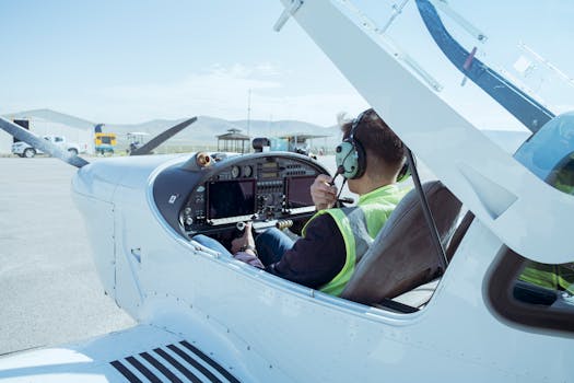 A pilot in the cockpit of a small aircraft readying for flight at Konya Airport, Türkiye.