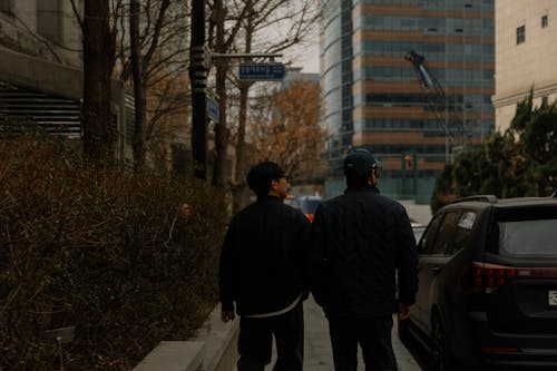 Two men walking down a city street