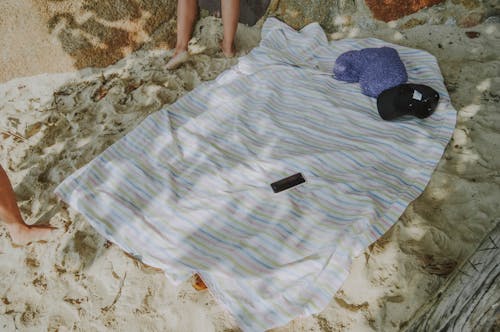 Free stock photo of beach, blanket, foot