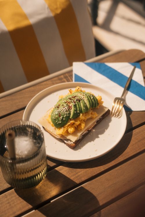 Free Delicious avocado toast with scrambled eggs, perfect for a sunny breakfast or brunch. Stock Photo