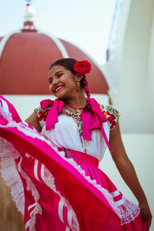Free A joyful woman in traditional Mexican attire dances in Oaxaca, Mexico. Stock Photo