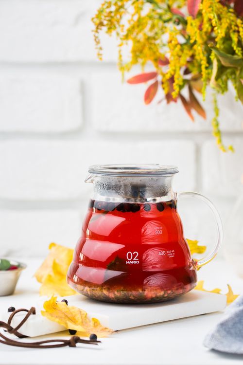 Free Aesthetic hot herbal tea in a glass teapot with colorful autumn elements. Stock Photo
