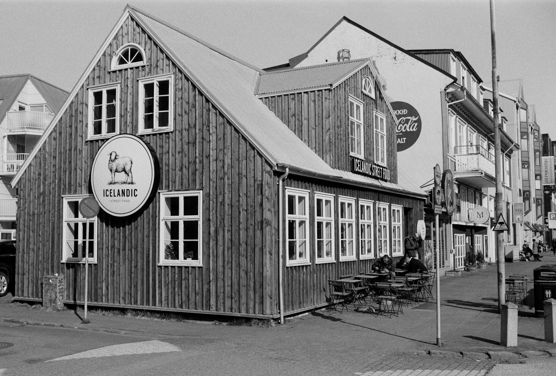Black and white photo of Icelandic wooden building on a Reykjavik street.