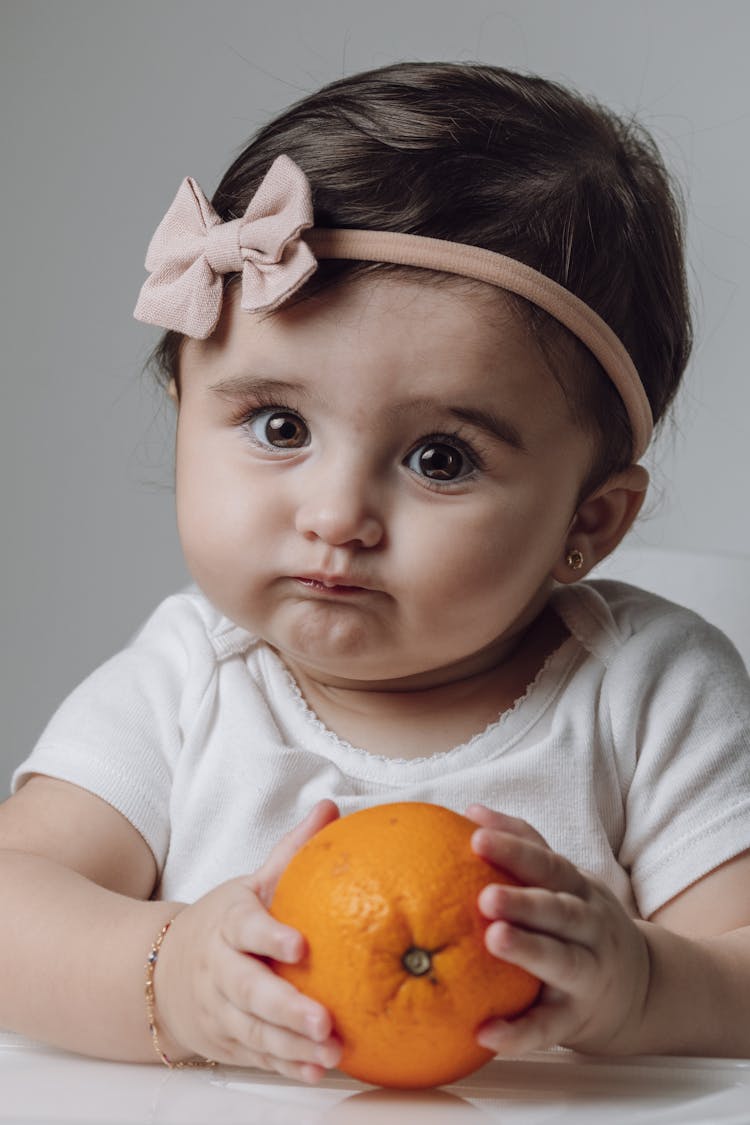 A Child With An Orange 