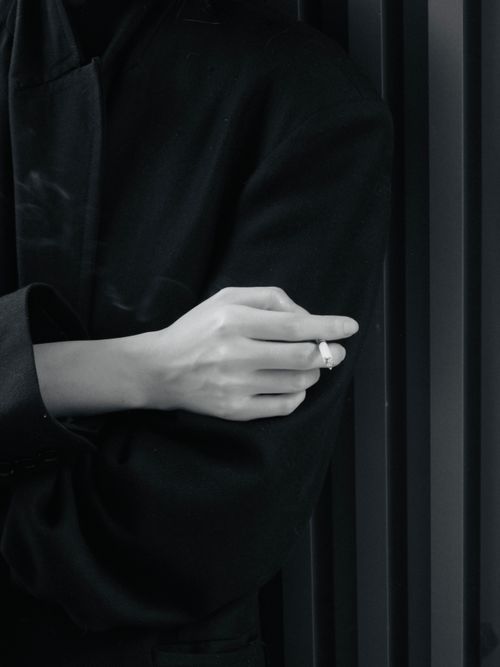 Free Artistic black and white photo of a smoker's hand holding a cigarette. Stock Photo