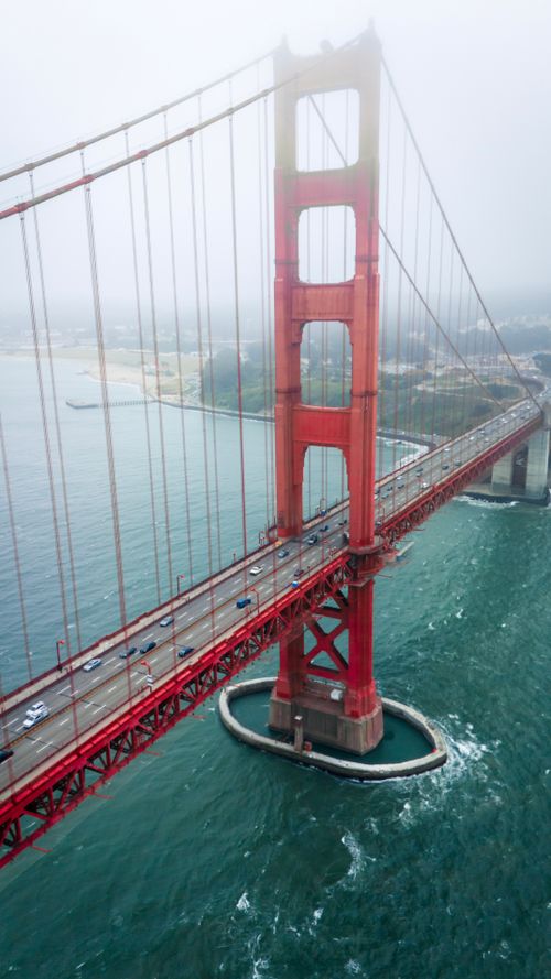 Free Aerial view of the Golden Gate Bridge shrouded in fog over San Francisco Bay. Stock Photo