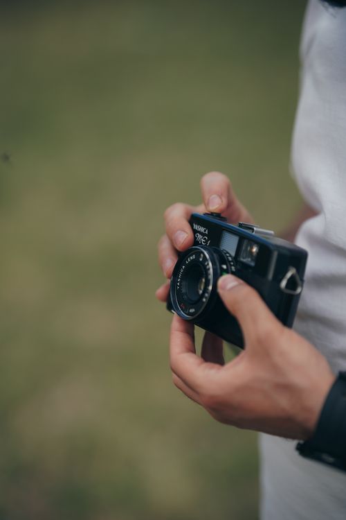 Free A person holds a vintage Yashica ME 1 camera outside, showcasing classic photography equipment. Stock Photo