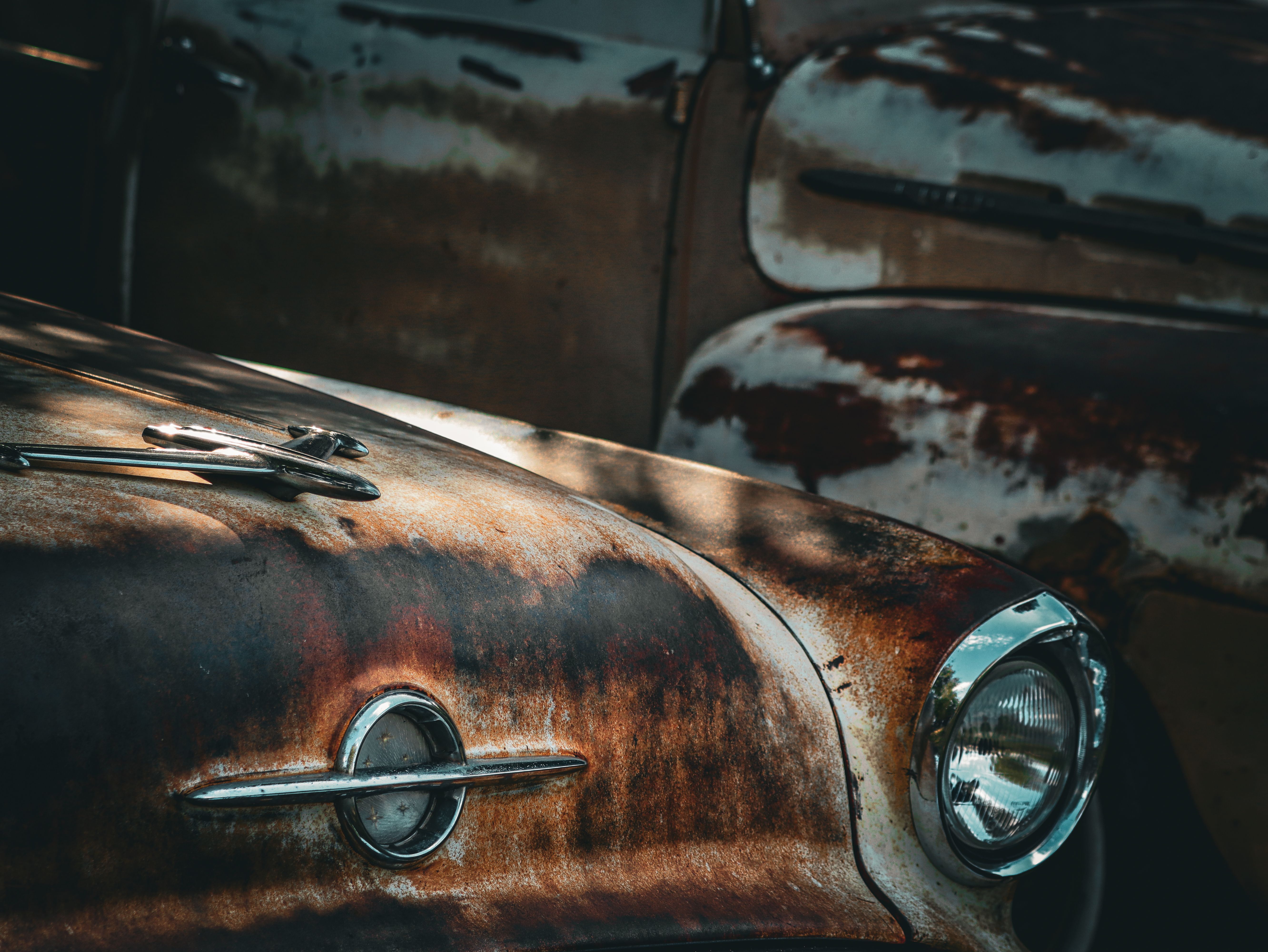 An old rusty car with a hood and headlights · Free Stock Photo