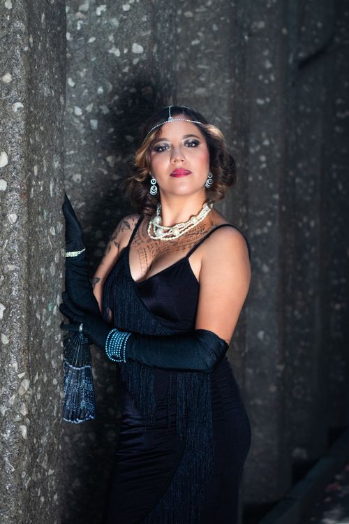 Free Sophisticated woman in evening wear posing indoors with vintage accessories. Stock Photo
