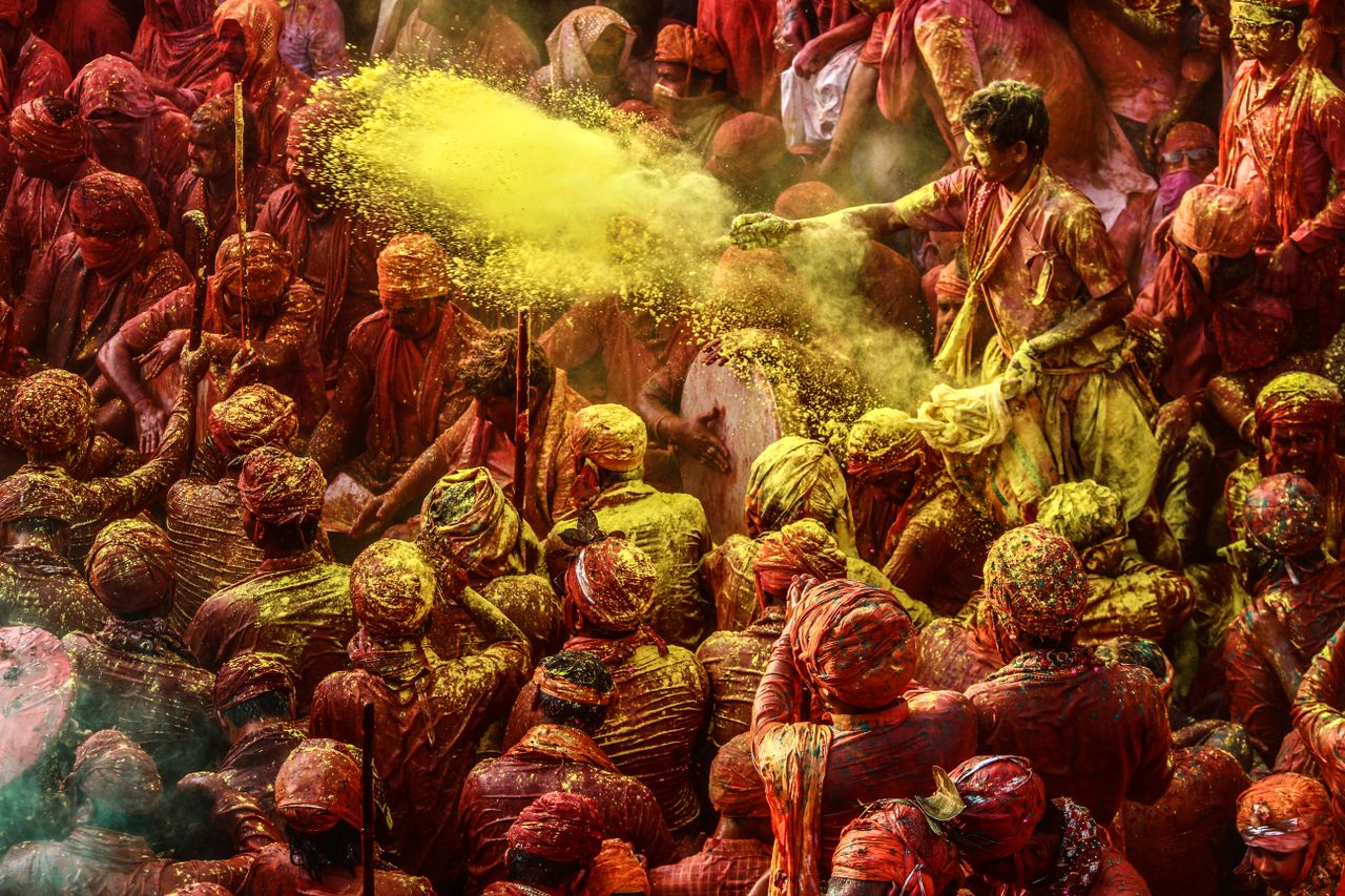 crowd celebrating holi festival with colorful powders in vibrant outdo