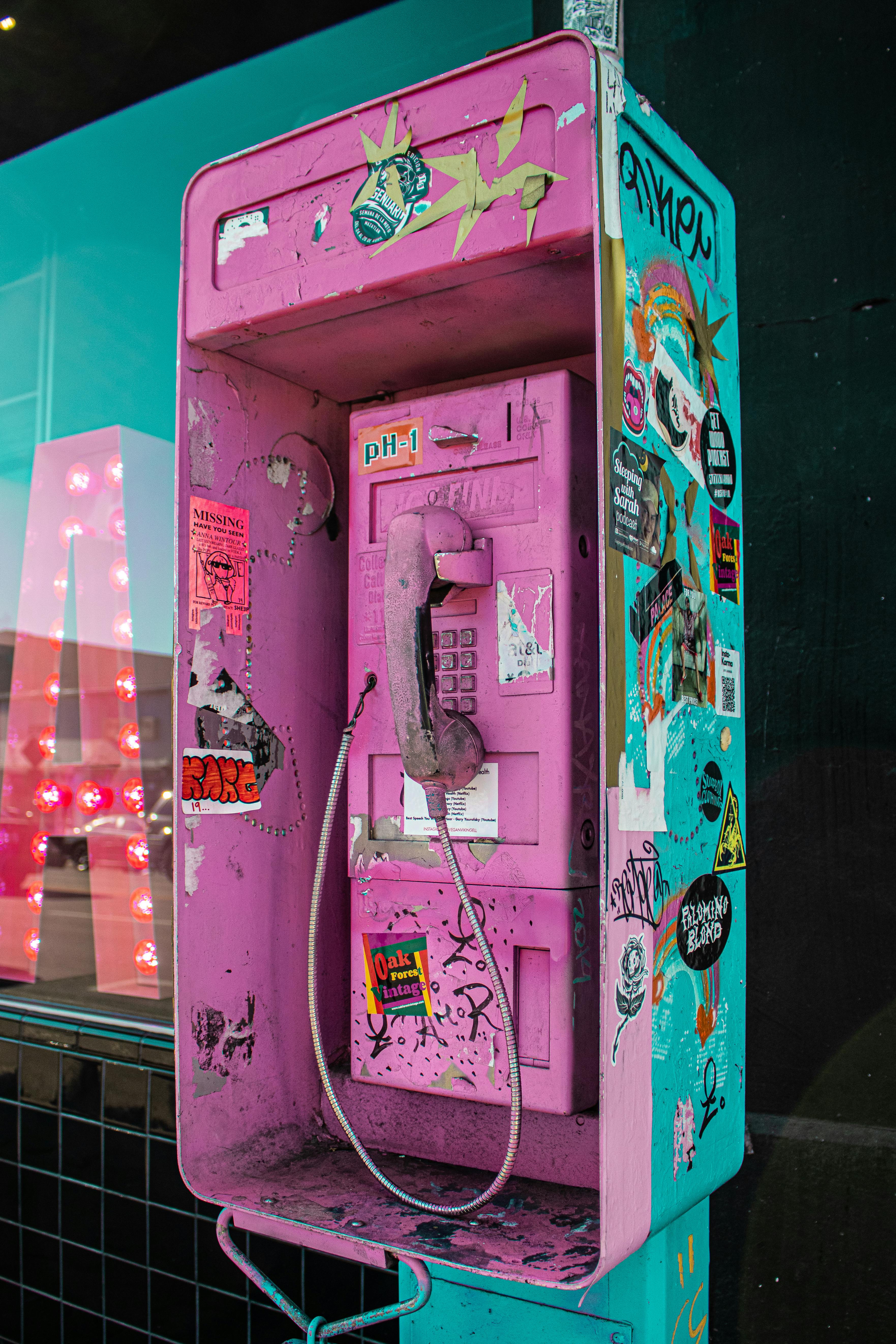 photo of pink and blue telephone booth