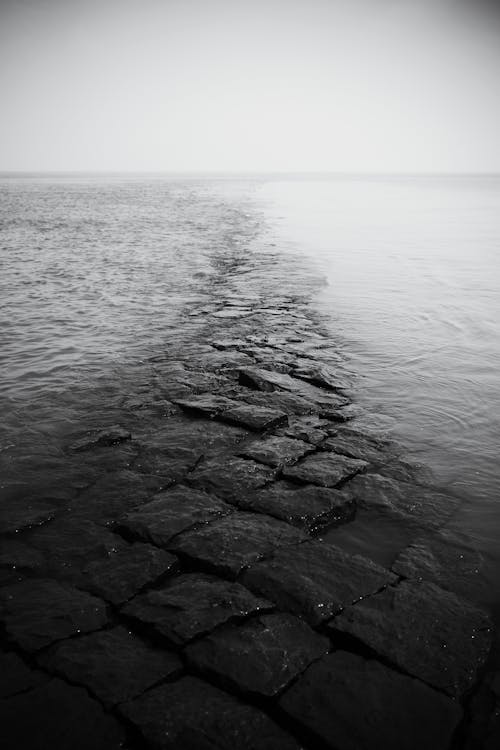 A black and white photo of a stone walkway