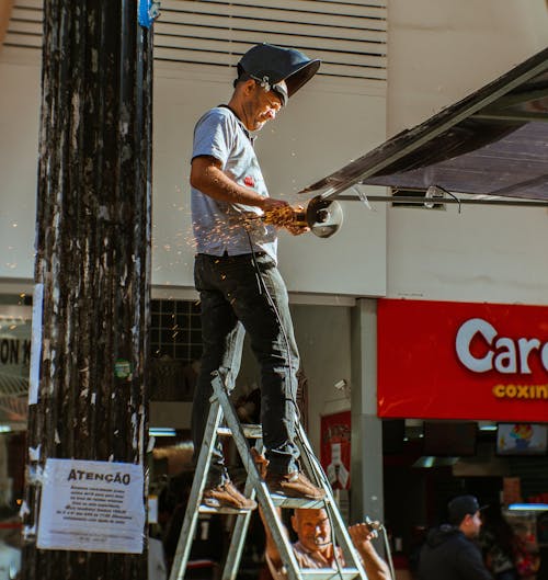 Person Using Angle Grinder Outdoors