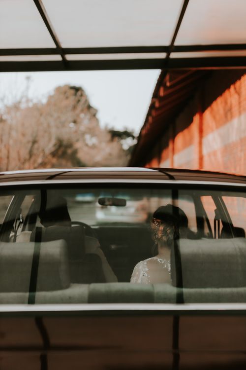 Free Bride in wedding dress seen through car window, heading to ceremony. Stock Photo