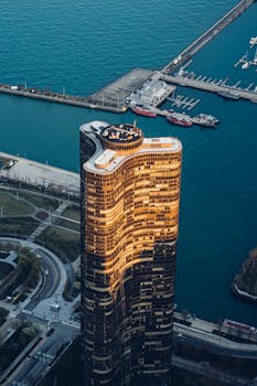 日落时分，海滨一座现代摩天大楼的戏剧性鸟瞰图