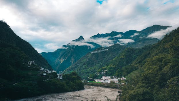 Explore the breathtaking Nujiang Valley with majestic mountains, lush greenery, and charming villages in Yunnan, China.