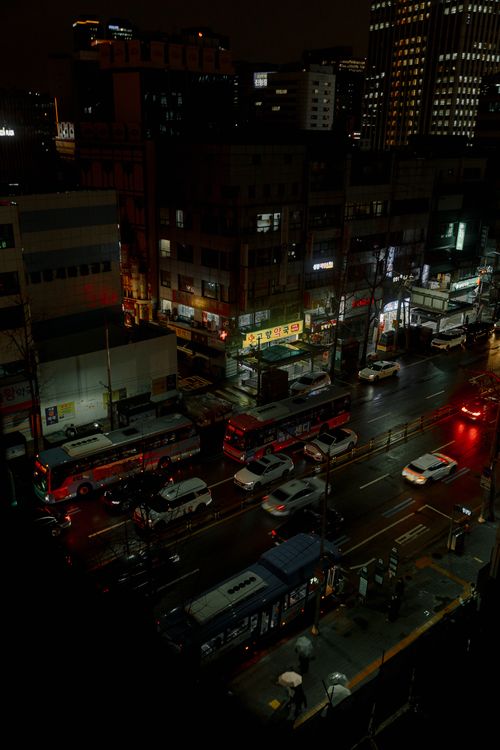 Free A busy urban street at night viewed from above with vibrant city lights and traffic. Stock Photo